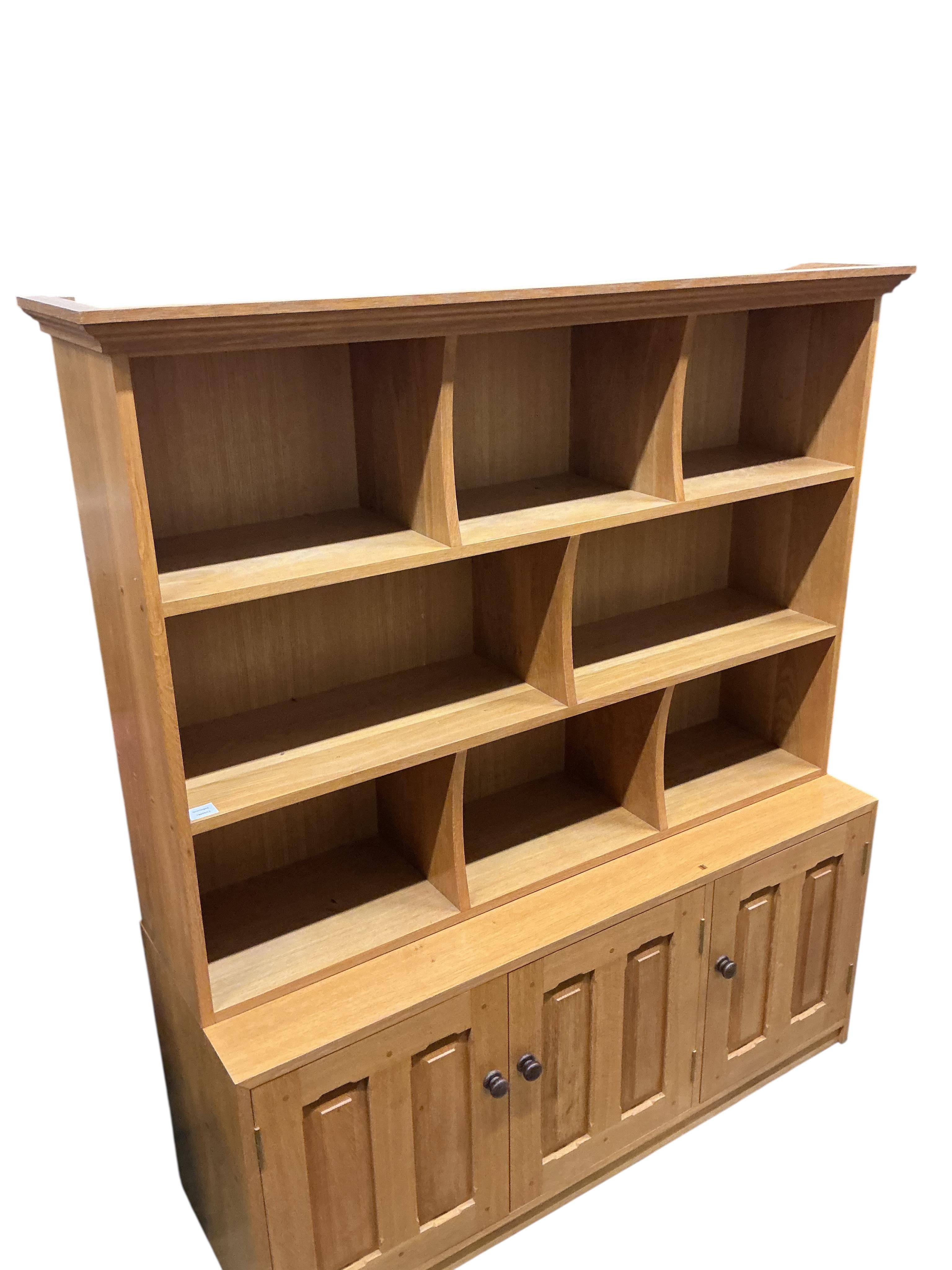 A Contemporary bespoke oak open bookcase, cupboards below, width 141cm, depth 46cm, height 169cm
